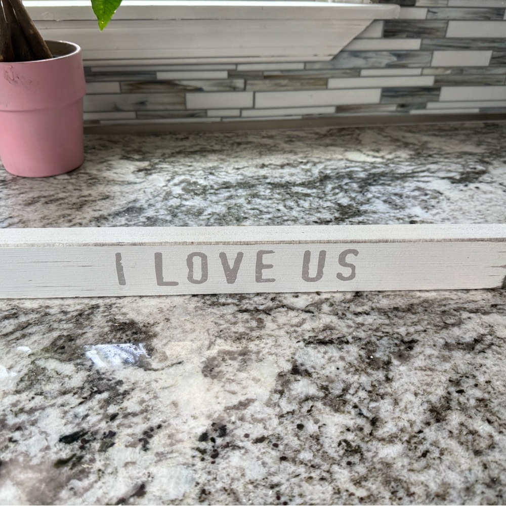 White Decorative Sign with 'I Love Us' Text